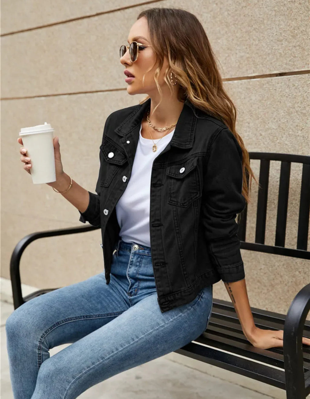 Close-up view of cropped denim jacket showing structured collar and button-front closure detail