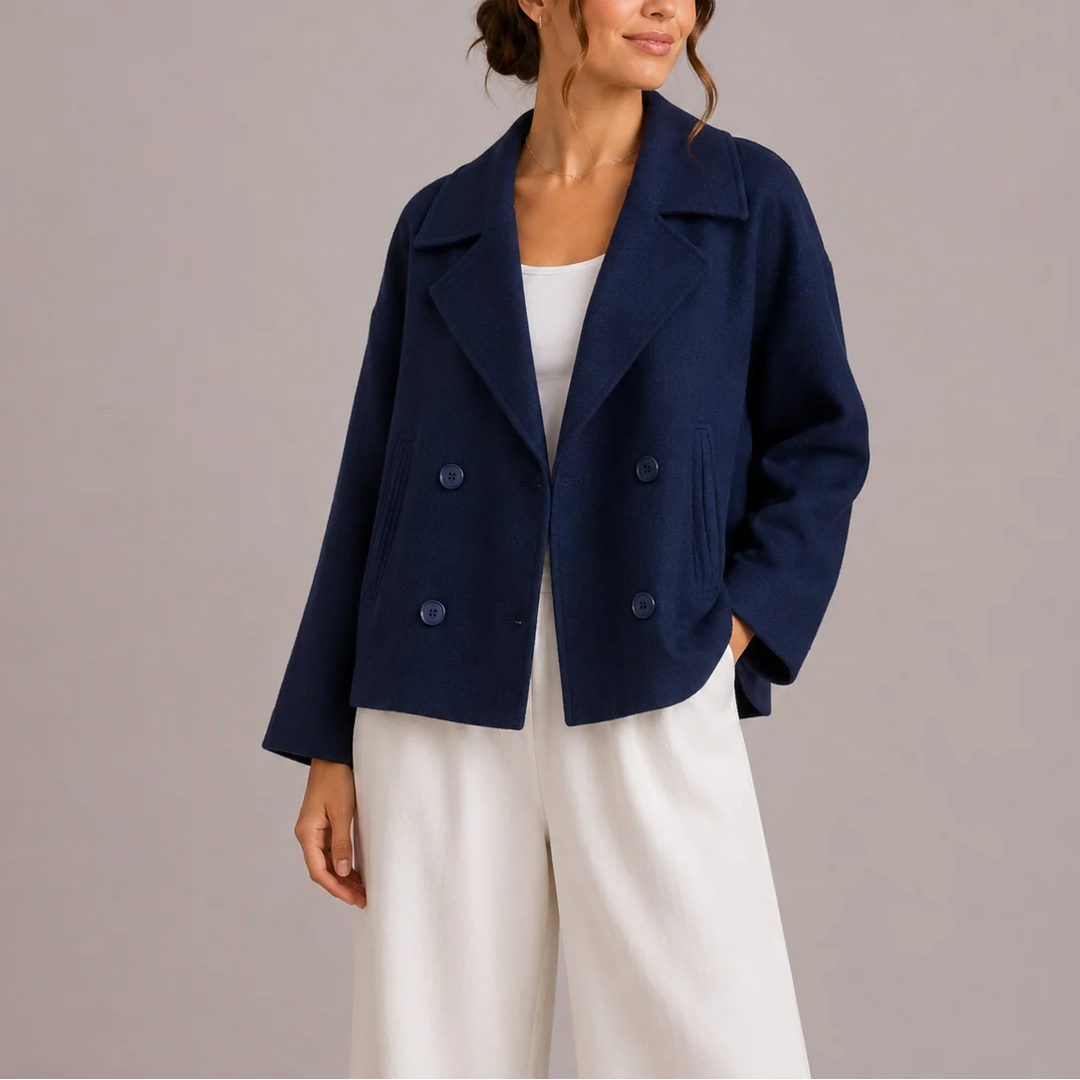 Detail of notched lapel collar and welt pockets on women's structured blazer