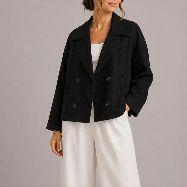 Full-length view of women's double-breasted blazer with tailored silhouette and cropped hem