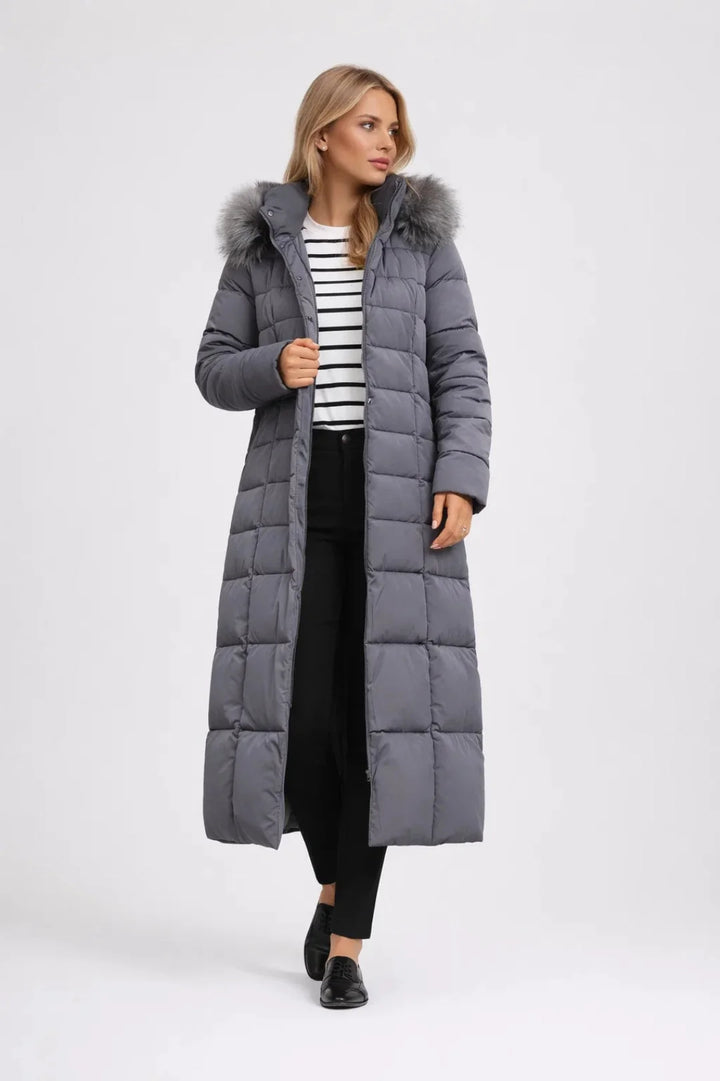 Close-up of women's long puffer coat featuring snap-button closure, faux fur hood trim, and side pockets