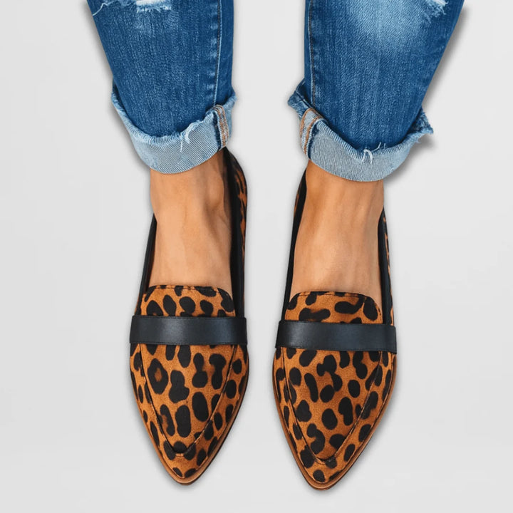 Women's suede loafers in neutral tan shade, showcasing pointed toe silhouette and flexible upper