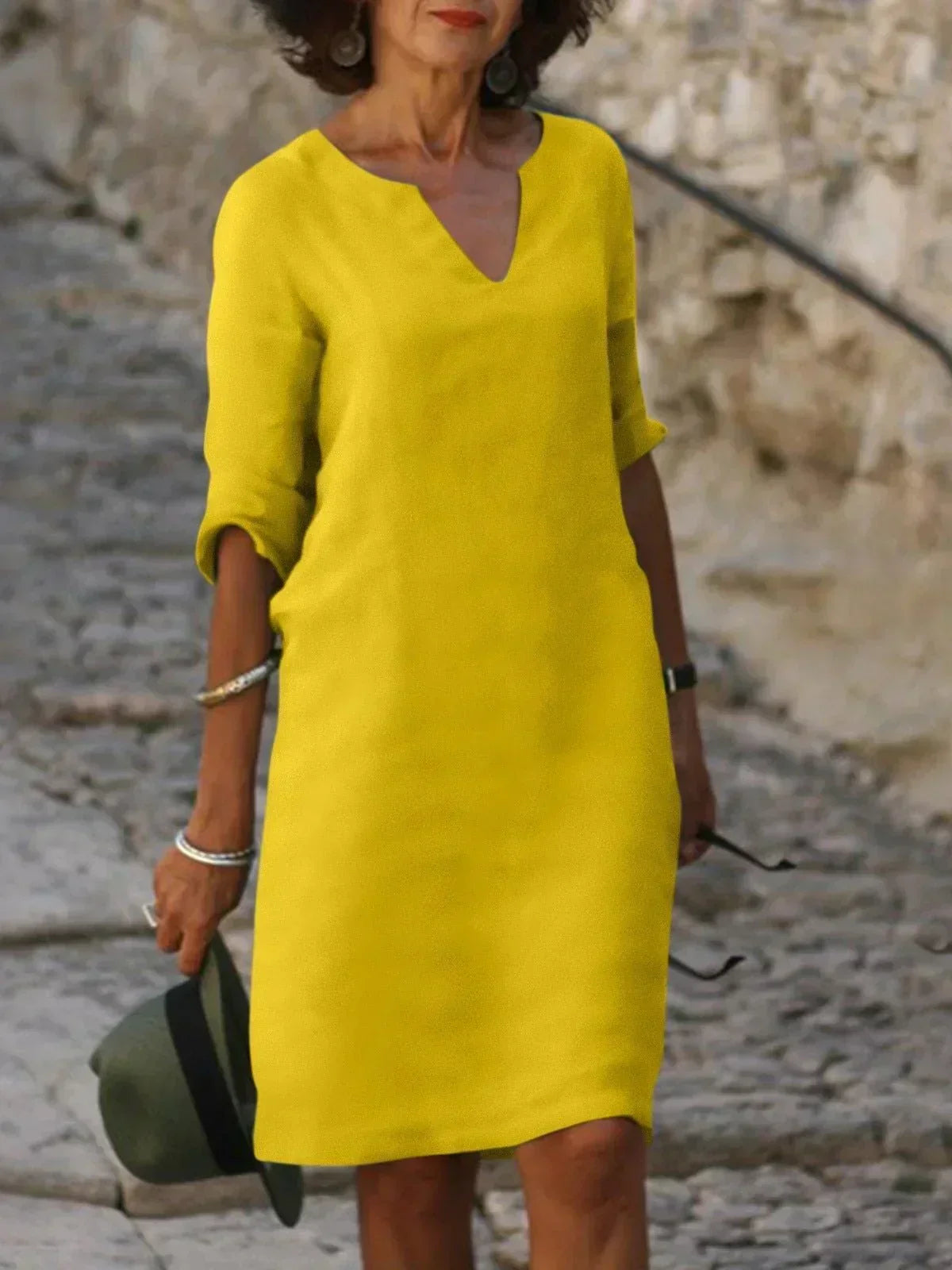 Full-length view of knee-length midi dress in black showing flattering a-line cut and drape
