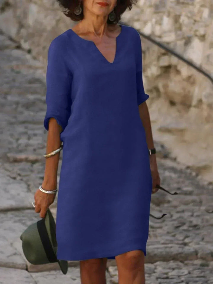 Close-up of three-quarter sleeve detail on v-neck midi dress with adjustable roll-tab feature