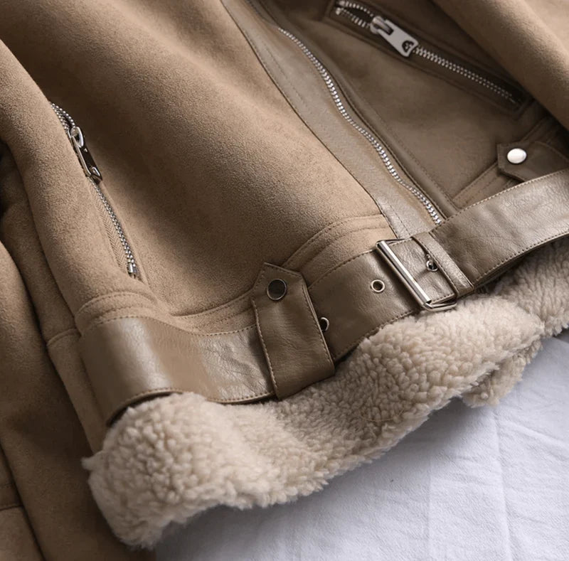 Detail of women's aviator jacket cuffs with sherpa trim and adjustable snap fastening