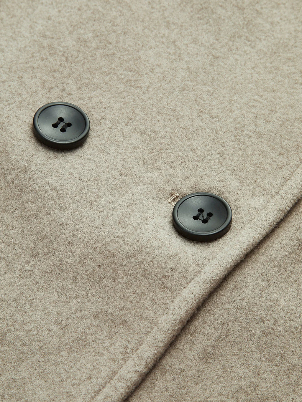 Women's pea coat styled over knitwear showing layering versatility