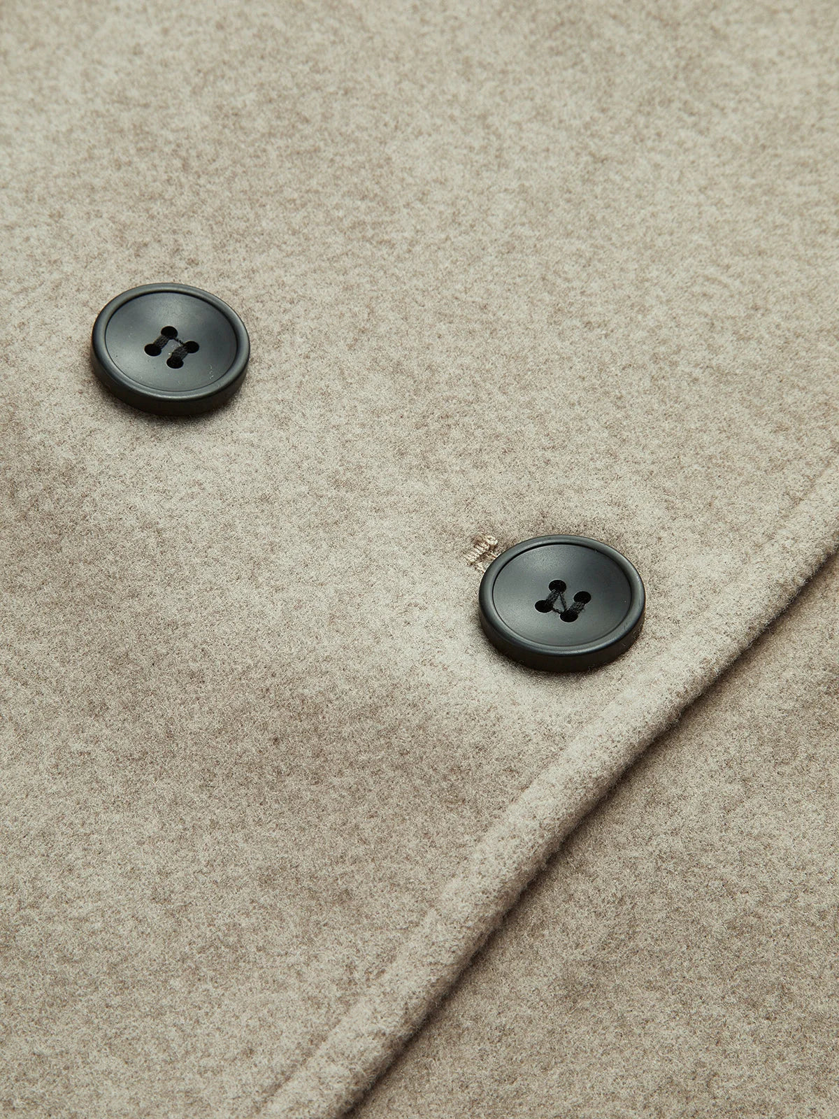 Women's pea coat styled over knitwear showing layering versatility