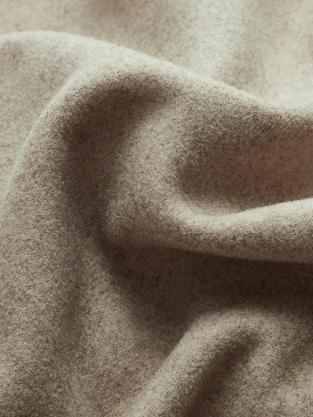 Close-up of structured fabric and tailored details on women's pea coat