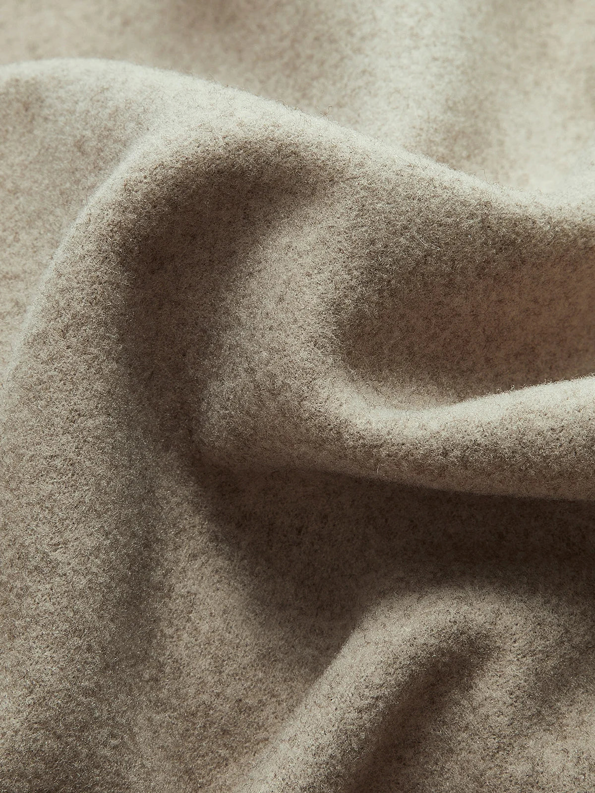 Close-up of structured fabric and tailored details on women's pea coat