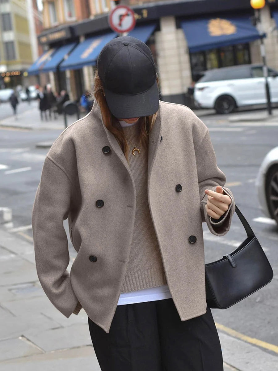 Side view of relaxed fit women's pea coat showing cropped length and structured drape