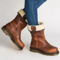 Women's fur-lined ankle boots in brown with sherpa collar and chunky sole worn with denim jeans