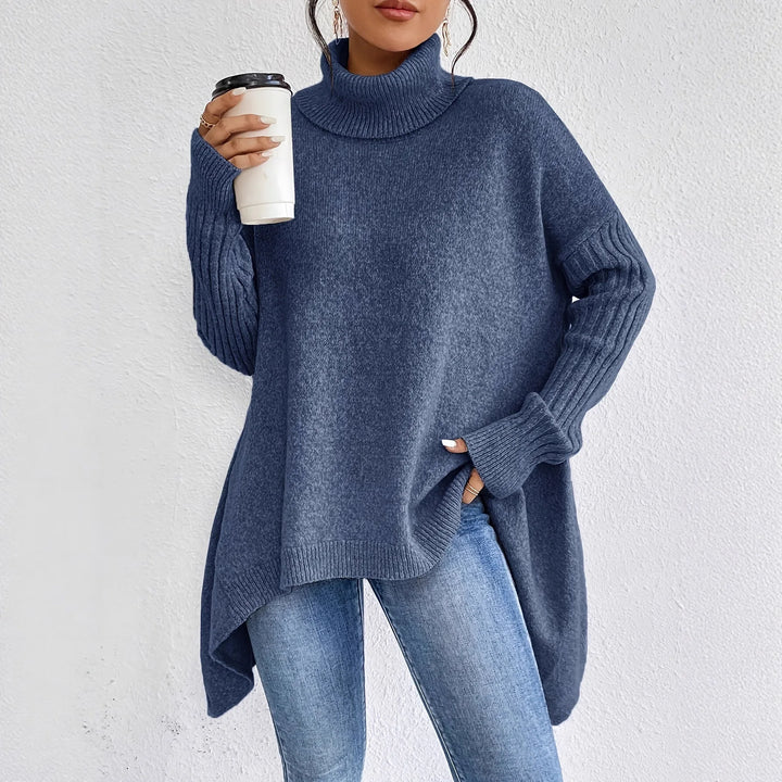 Close-up view of women's oversized turtleneck jumper showing ribbed collar and textured knit fabric detail