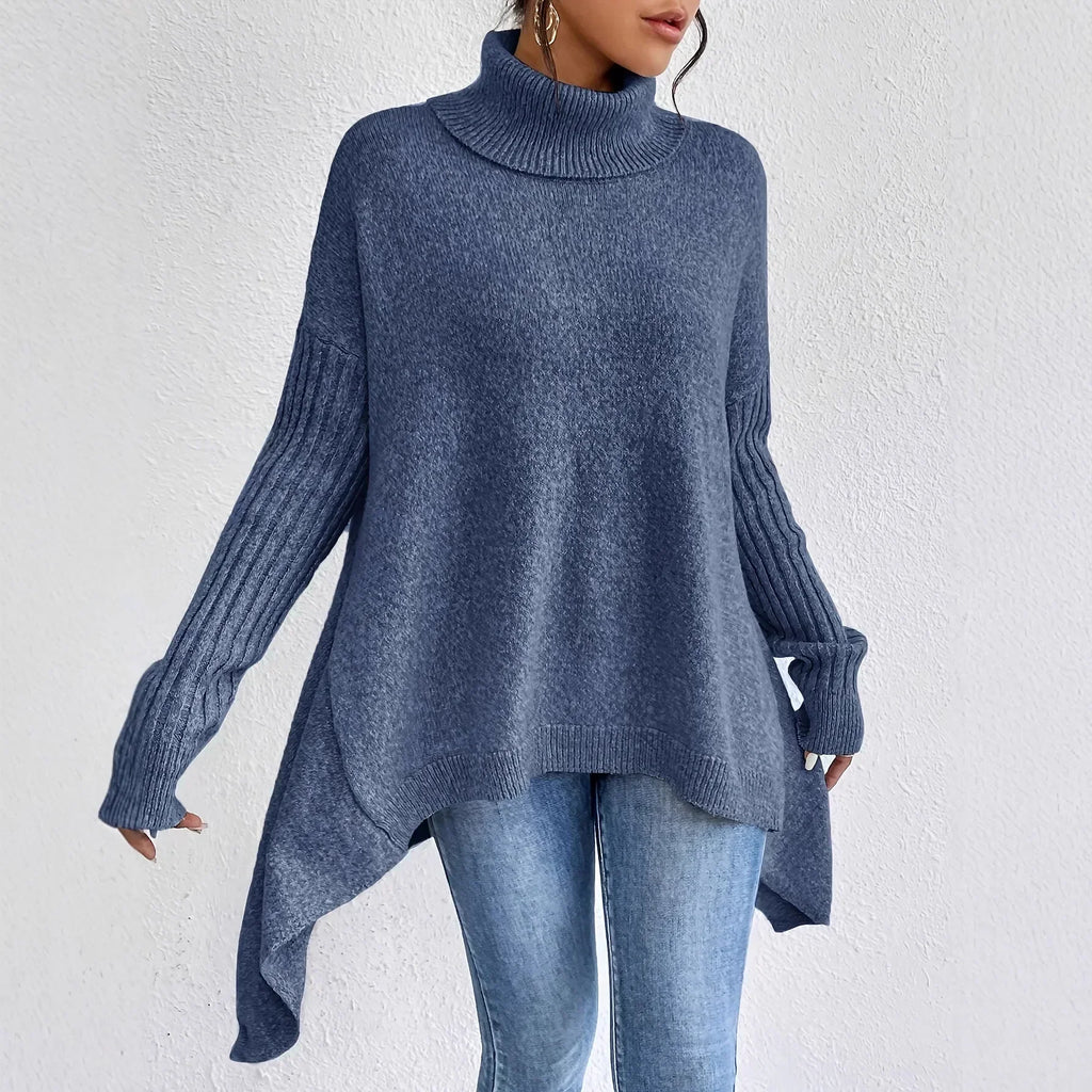 Rear view of women's oversized jumper showing relaxed silhouette and high-low hem construction detail