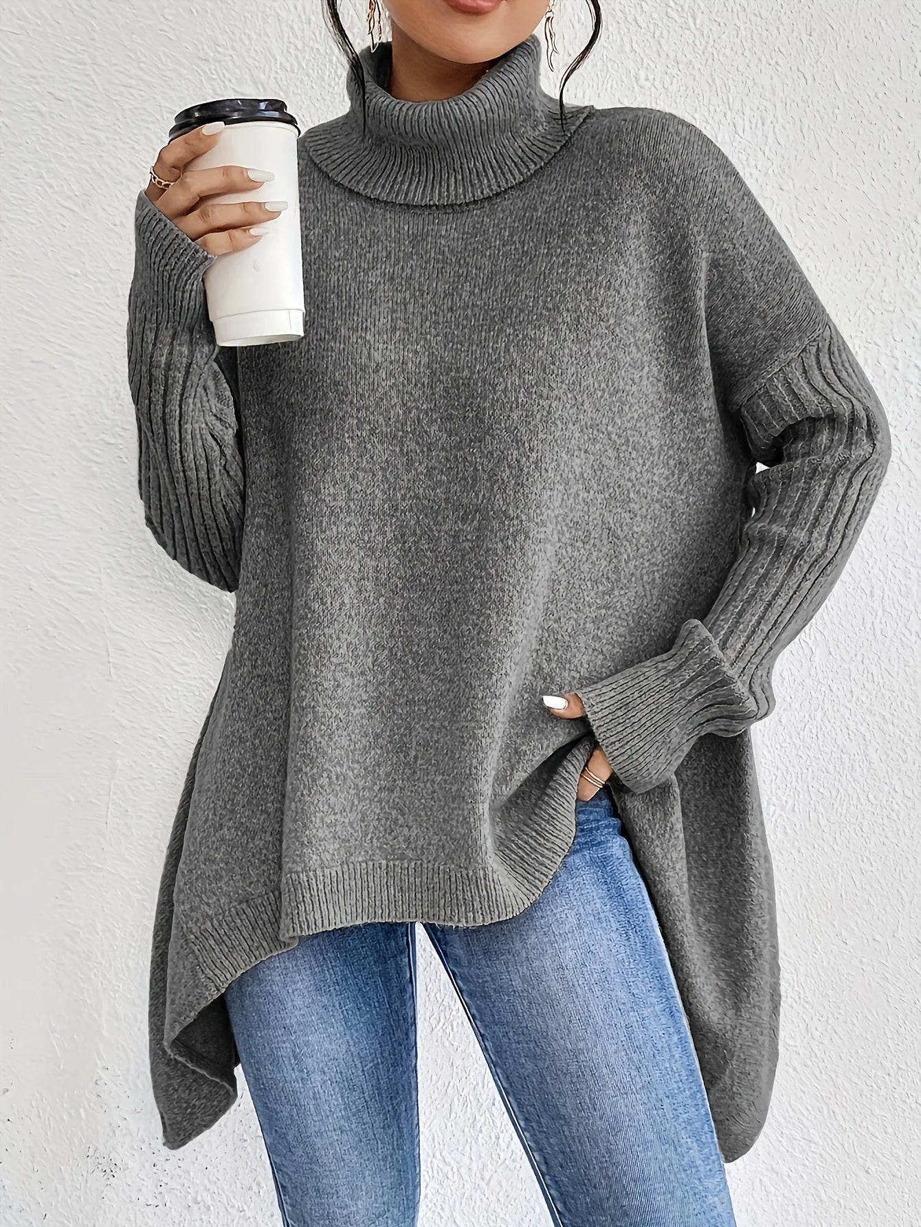 Woman styling oversized turtleneck jumper with jeans demonstrating layering versatility for casual autumn wear