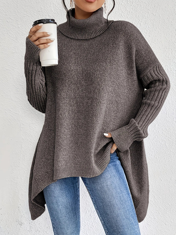Detail shot of ribbed cuffs and sleeve construction on women's oversized turtleneck jumper