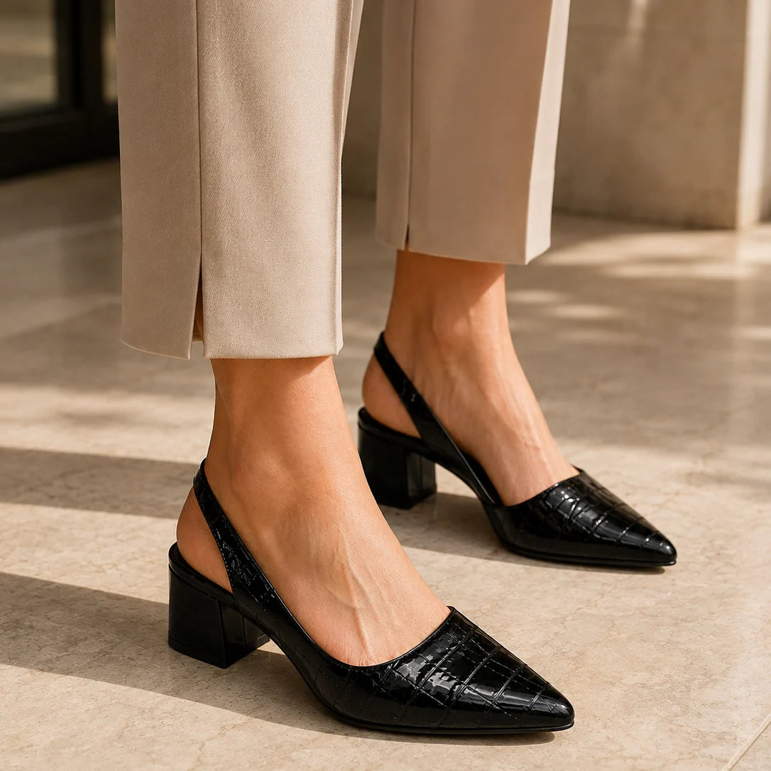 Chestnut brown slingback pumps on white background showing elegant pointed silhouette and heel height