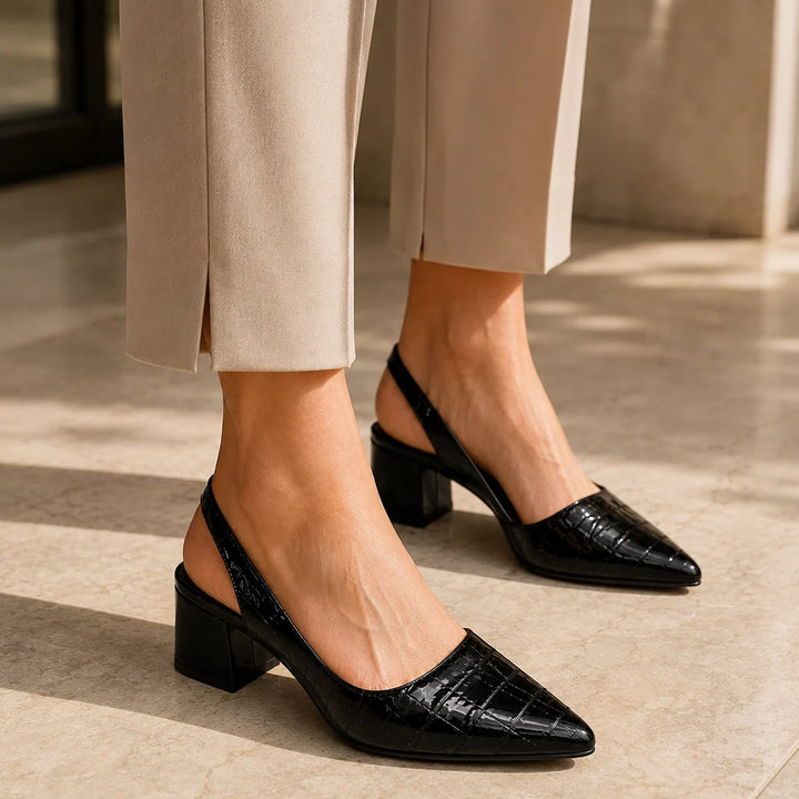Chestnut brown slingback pumps on white background showing elegant pointed silhouette and heel height