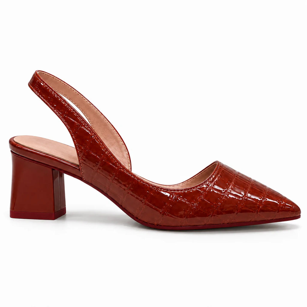 Close-up of crocodile-embossed texture on pointed-toe slingback heels in rich brown tone