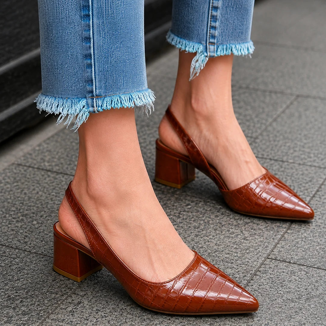 Detail of elastic slingback strap and cushioned footbed on women's block heel pumps