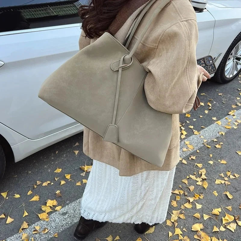 Women's structured tote bag styled on model showing shoulder carry and proportions