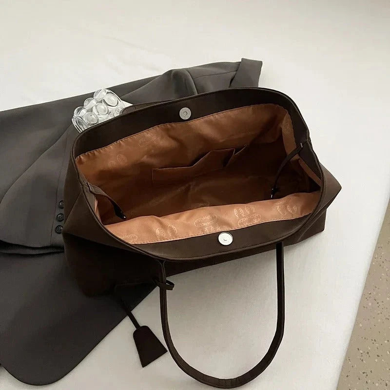 Detail shot of tote bag base showing structured construction and seam work