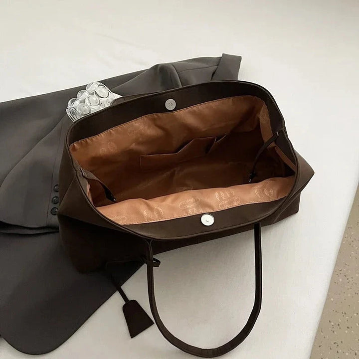 Detail shot of tote bag base showing structured construction and seam work