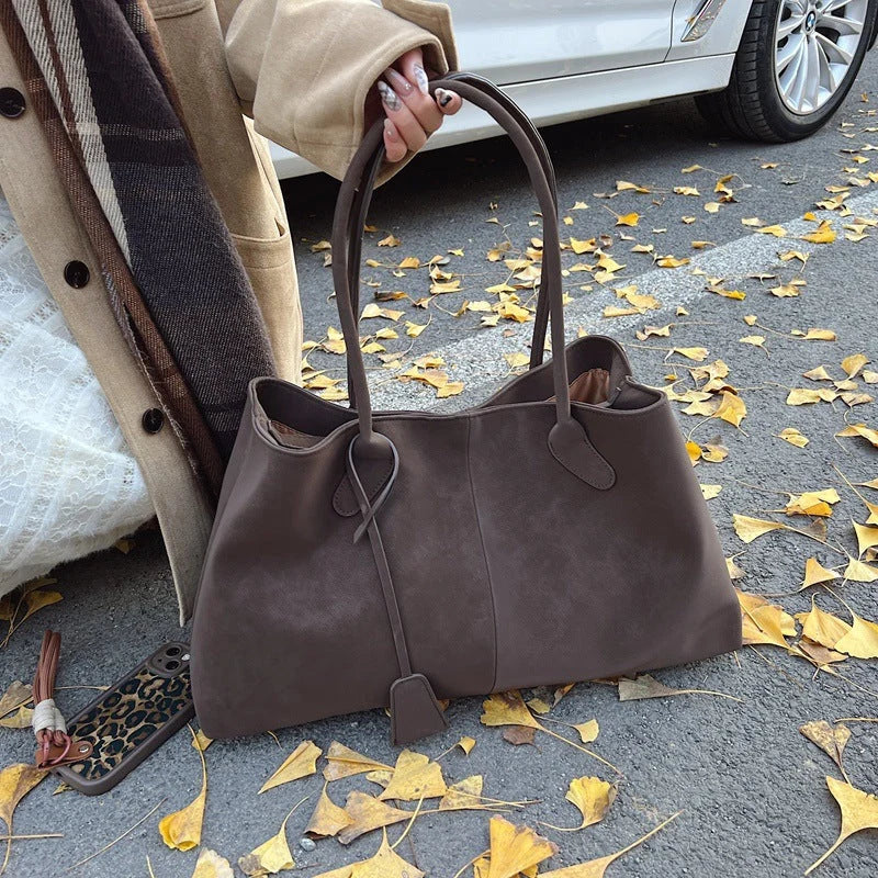 Women's tote bag carried by model in casual setting demonstrating everyday use