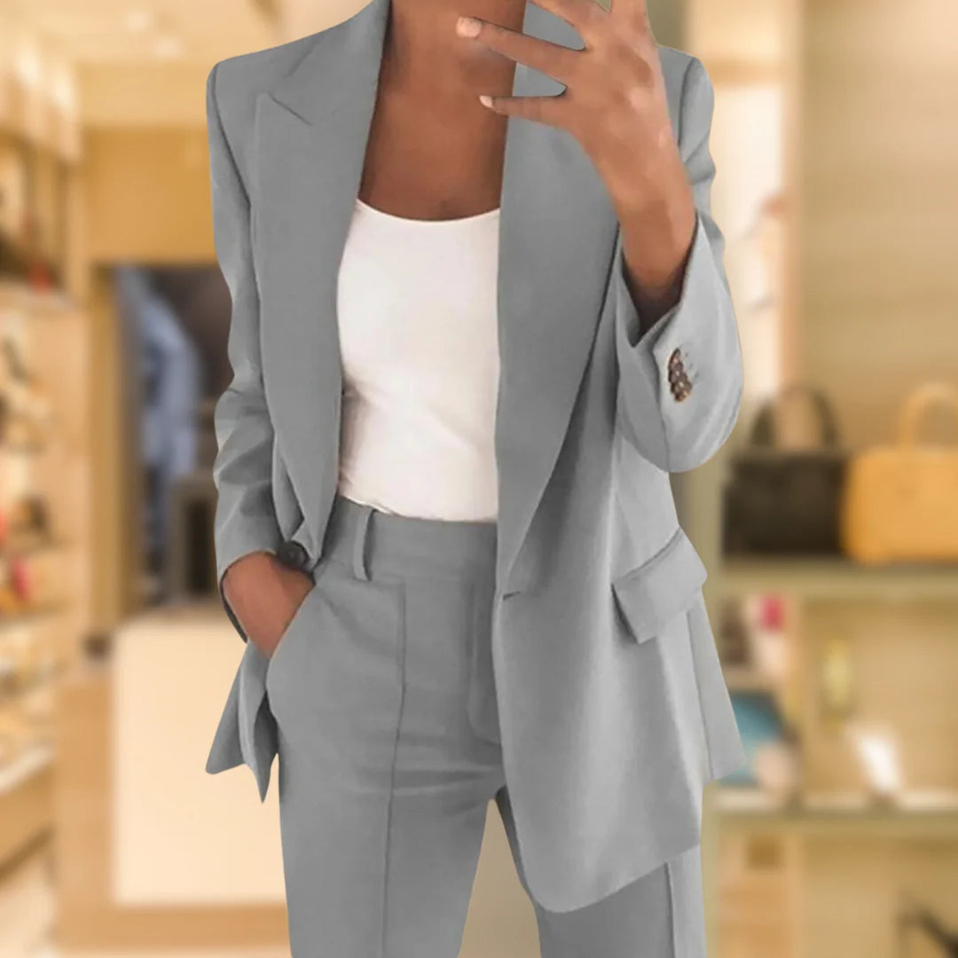 Close-up view of women's tailored blazer suit set showing notch lapels, single-button closure and straight-leg trousers