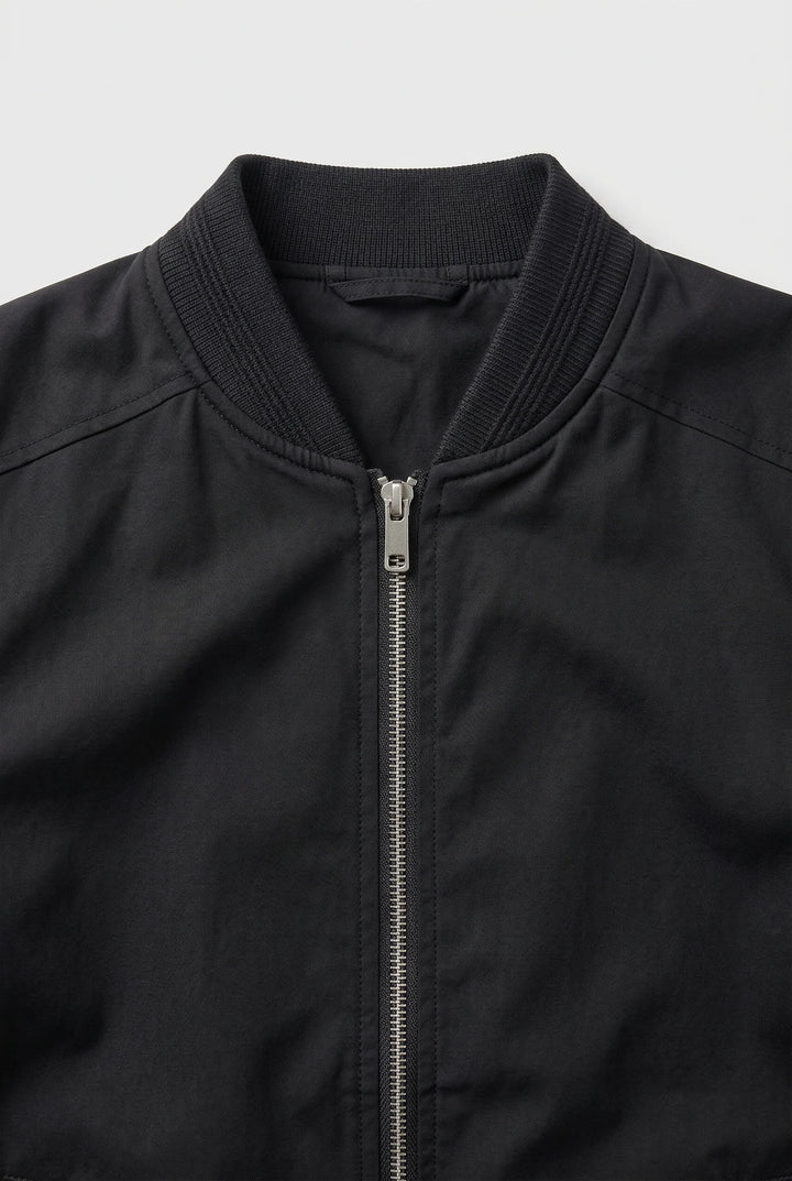 Men's bomber jacket side angle displaying relaxed fit and structured ribbed trims throughout