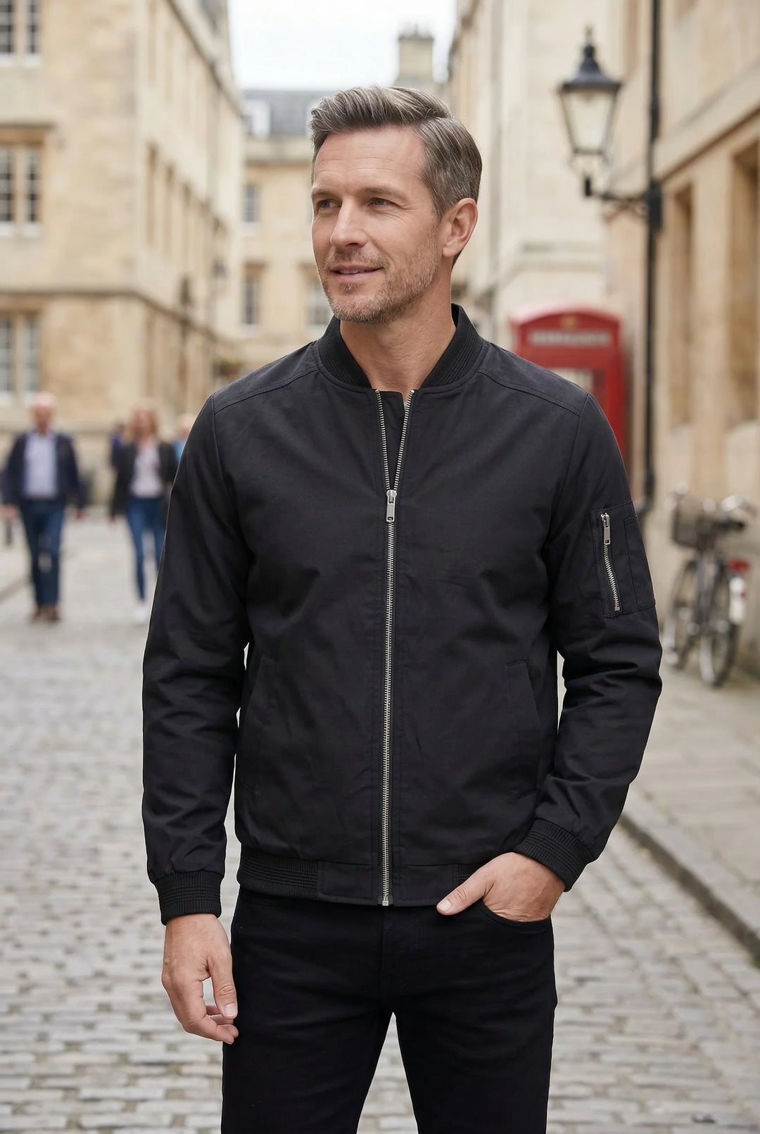 Detail shot of ribbed cuffs and hem on men's bomber jacket in black
