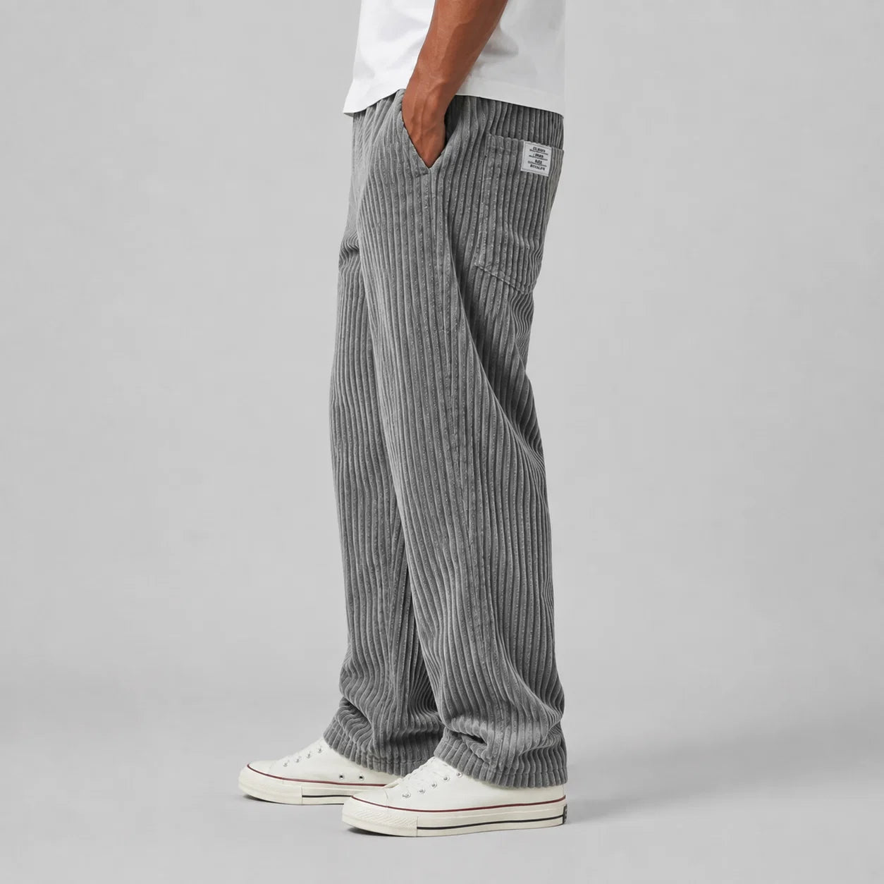 Relaxed fit men's corduroy trousers in grey paired with casual trainers
