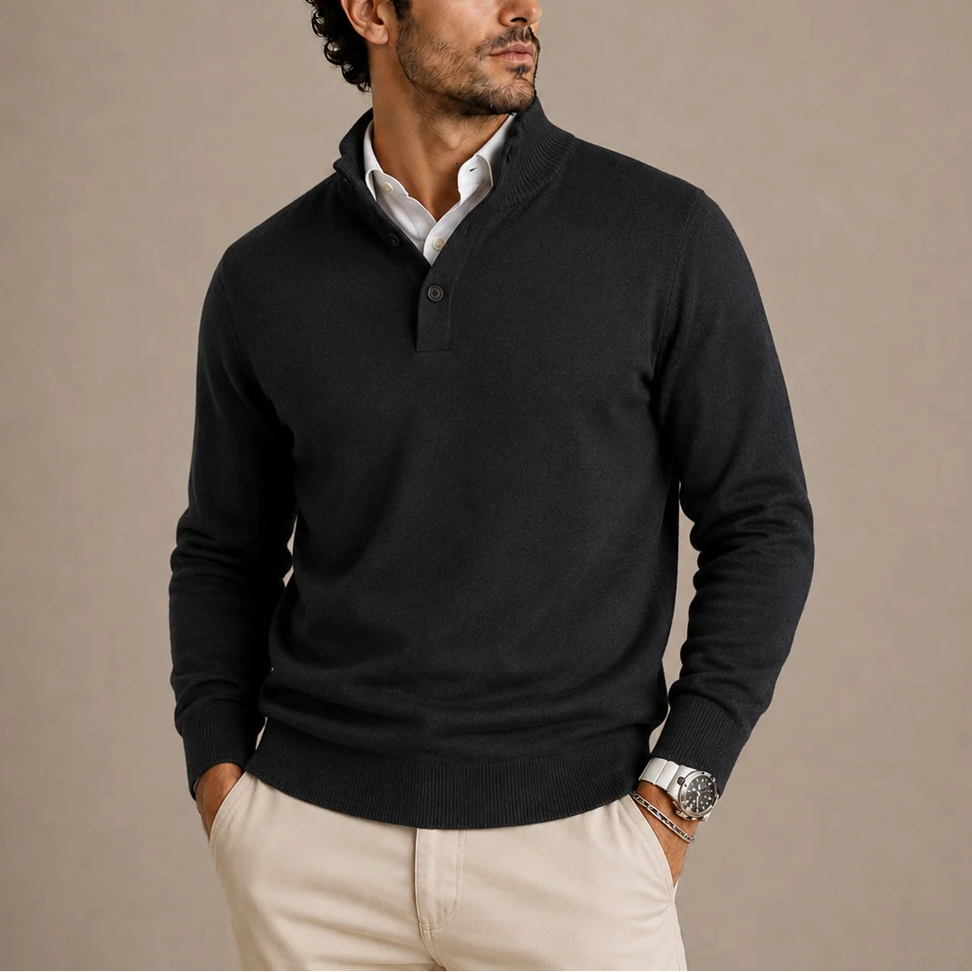 Men's knit polo jumper with three-button collar and long sleeves in black, styled with beige chinos.