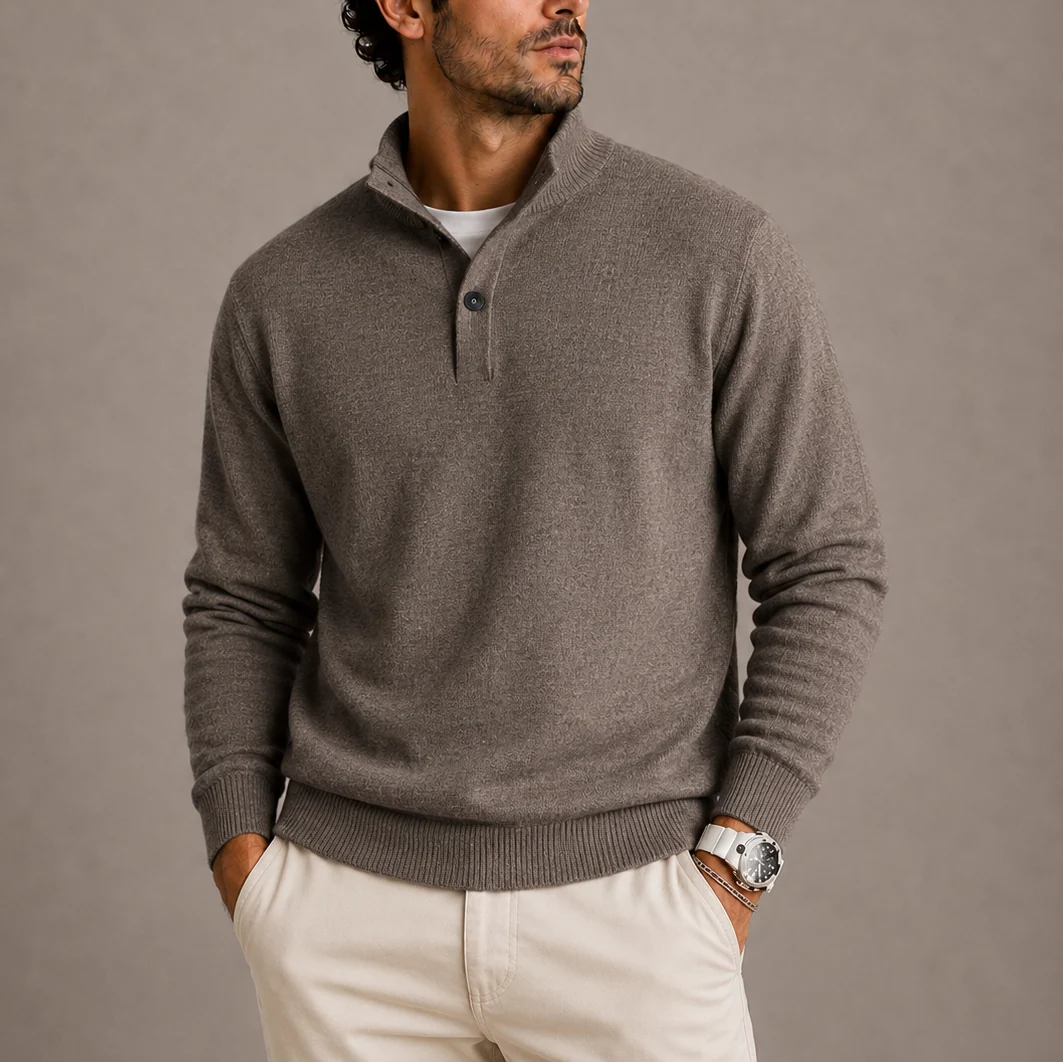 Close-up view of men's knit polo jumper showing structured knit fabric and ribbed cuffs.