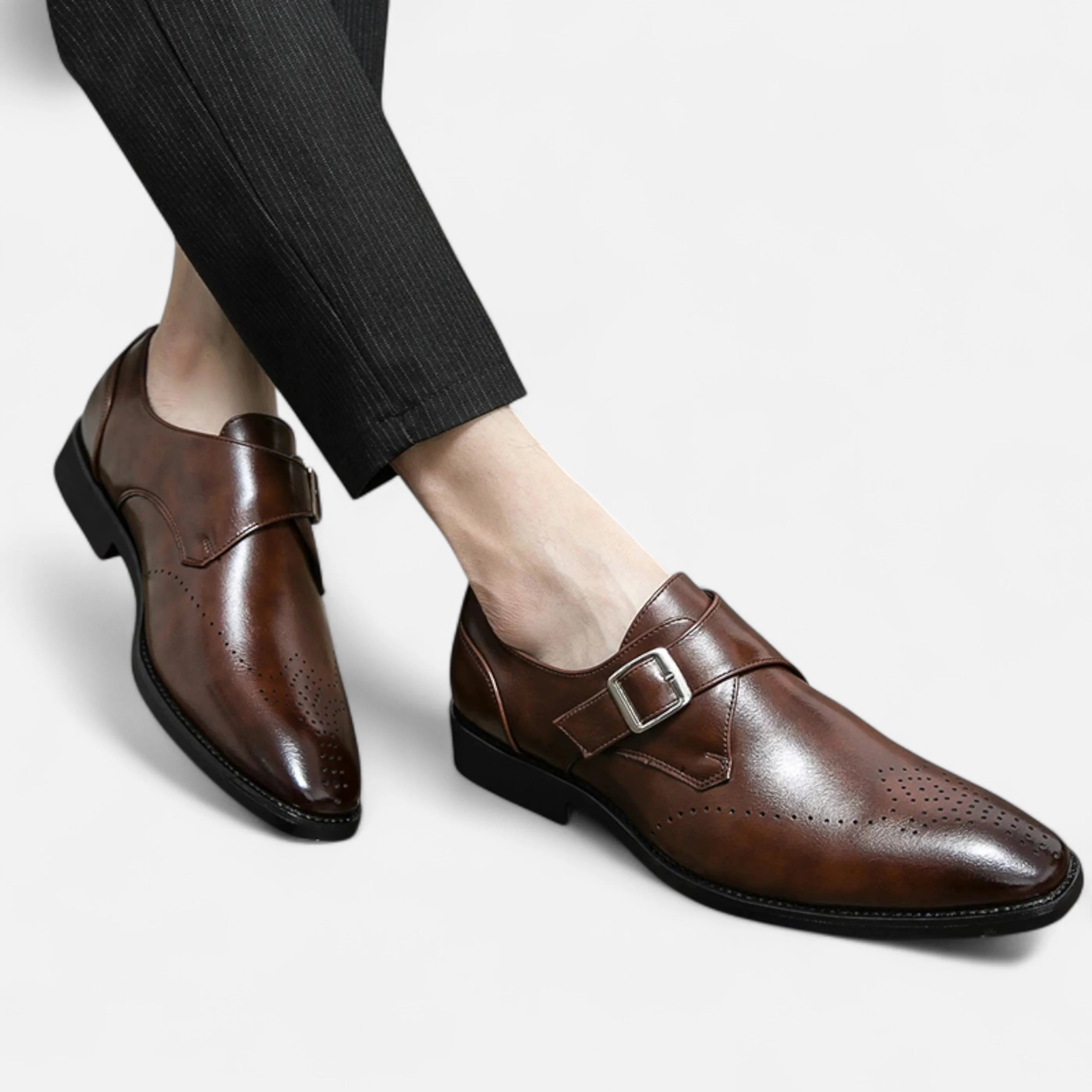 Black monk strap dress shoes with structured upper and refined almond toe shape