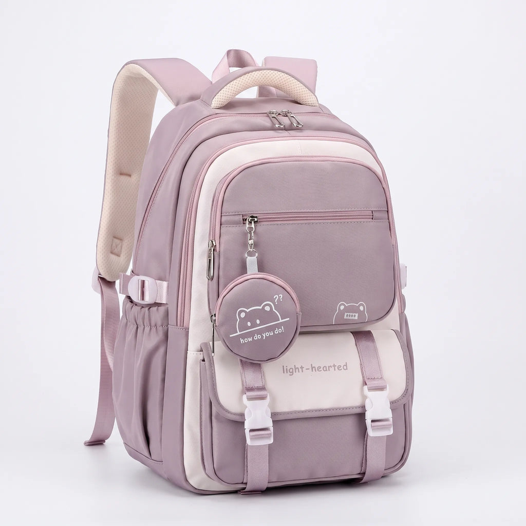 Close-up view of school backpack front panel with adjustable buckle straps and detachable bear coin purse