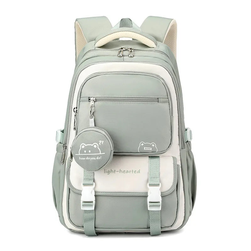 Close-up of school backpack front pocket zip with decorative bear graphic coin purse attachment