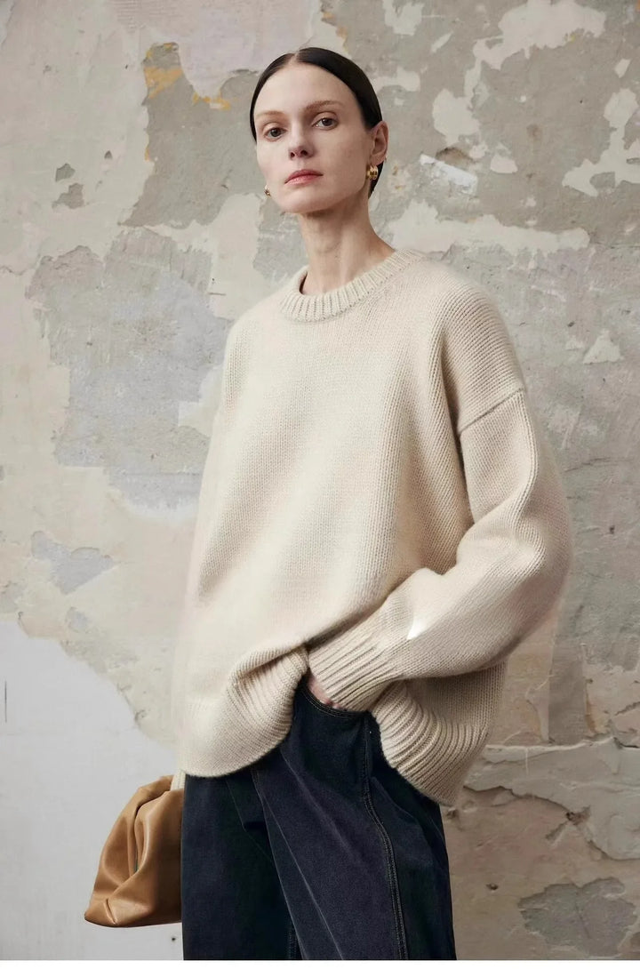 Oversized cashmere sweater styled for autumn layering with dark bottoms