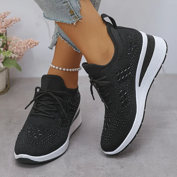 Close-up of mesh construction and crystal detailing on women's embellished trainers