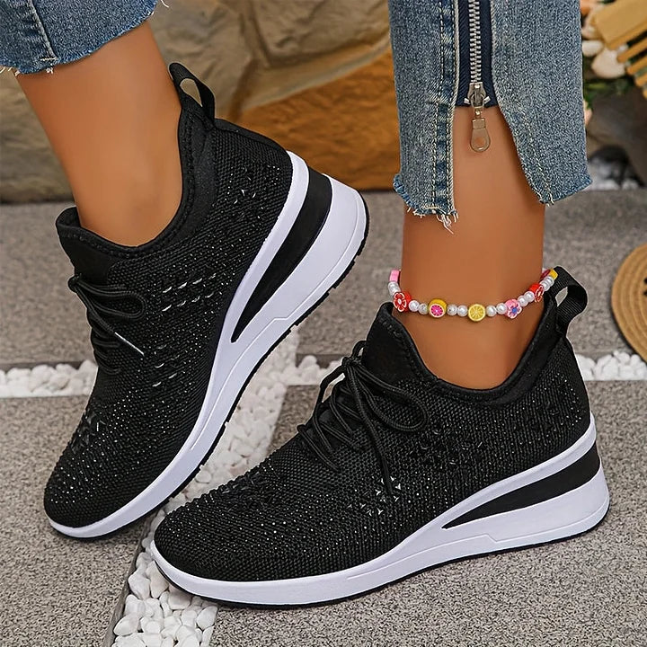 Side angle of women's embellished trainers showing structured fit and cushioned base