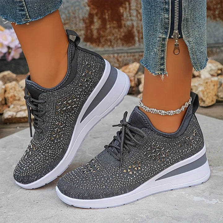 Detailed shot of women's trainers highlighting rhinestone pattern and mesh fabric