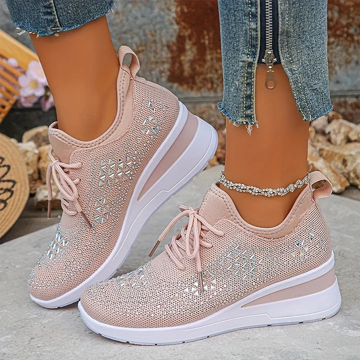 Women's embellished trainers displayed showing cushioned sole and grey accent stripe