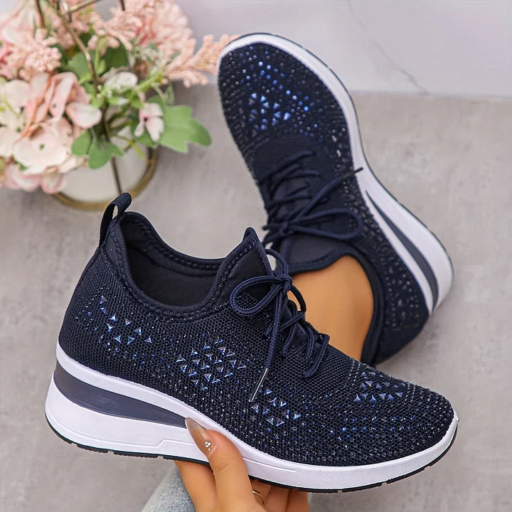 Side profile of women's embellished trainers highlighting cushioned sole and grey stripe accent
