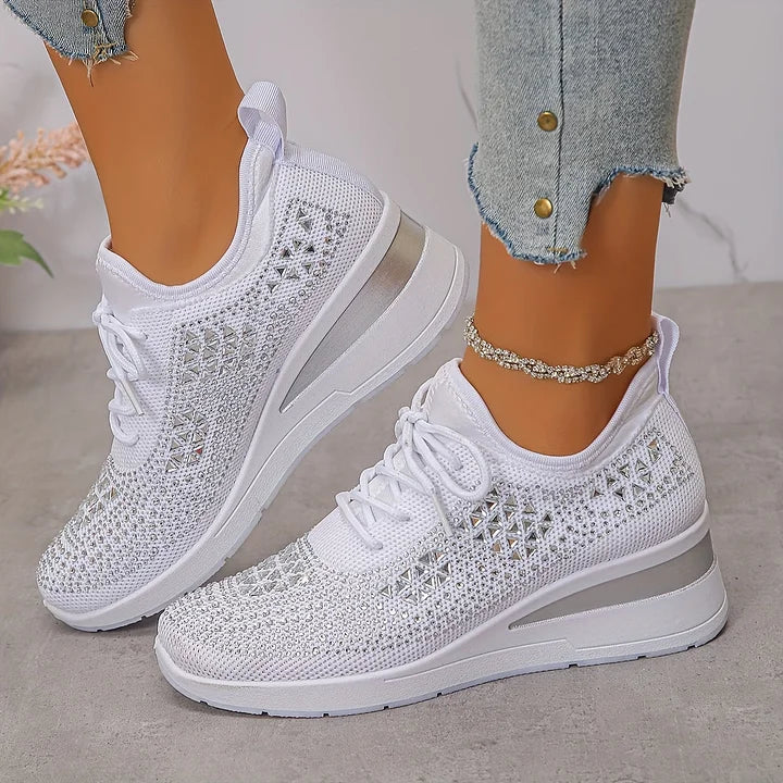Pair of women's trainers featuring rhinestone detailing and lace-up closure system