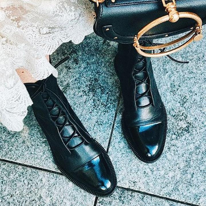 Full view of women's structured ankle boots with lace-up front and chunky base