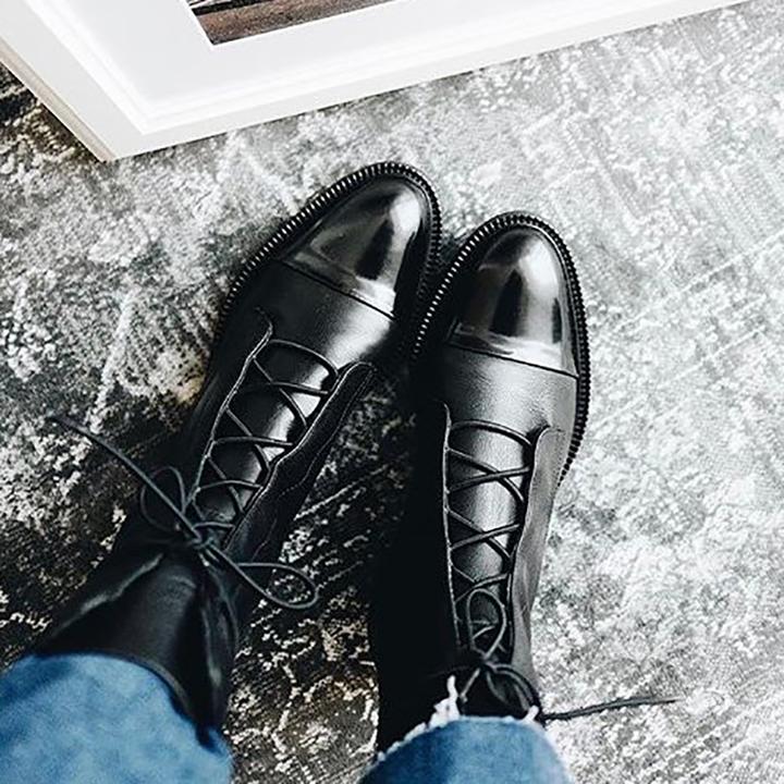 Black ankle boots with lace detail shown from multiple angles on light background