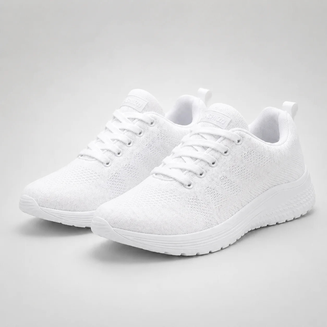 Top view of women's knit trainers showing breathable mesh upper and padded tongue