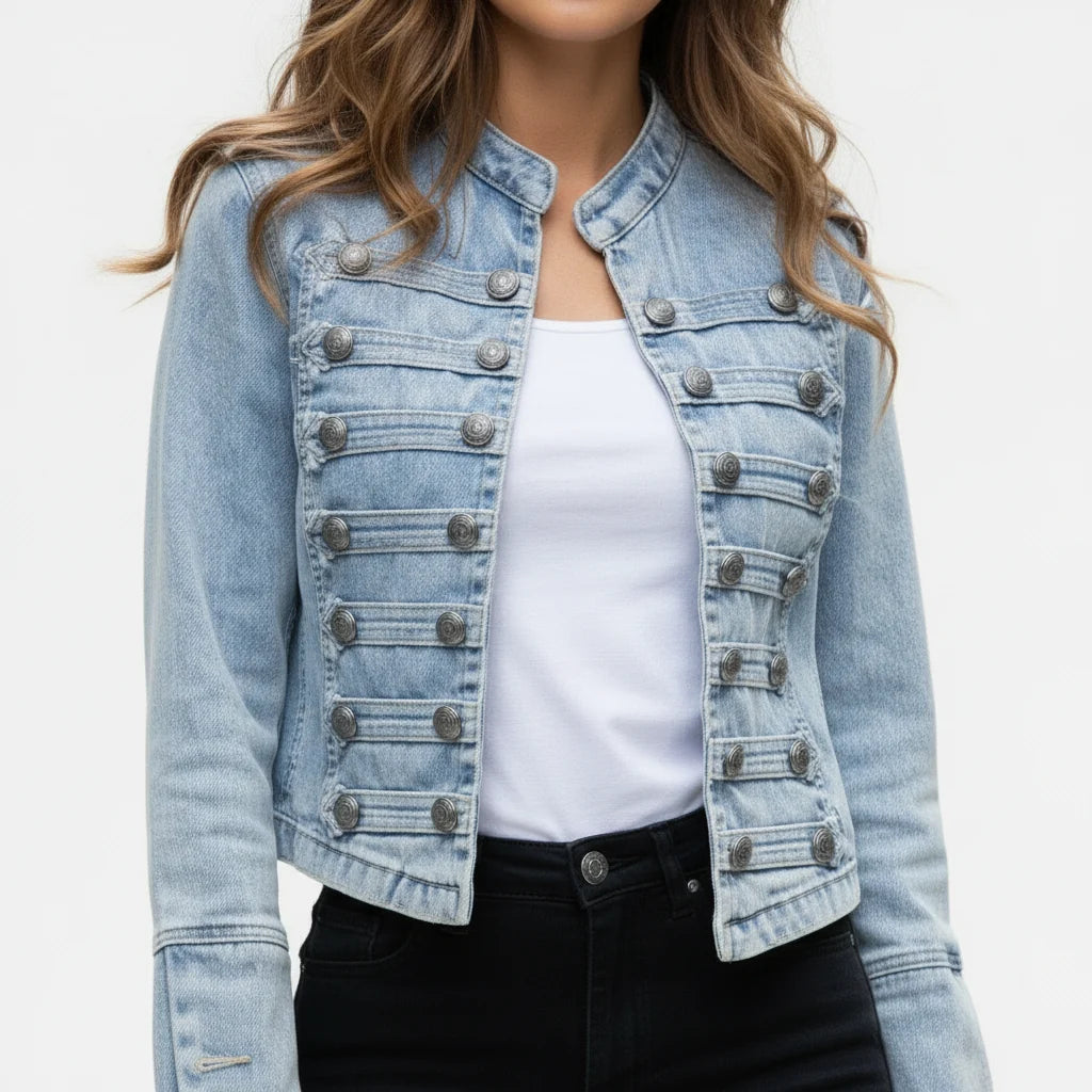 Close-up of decorative button rows and epaulette detailing on women's military denim jacket