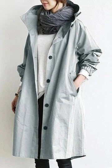 Women's oversized hooded trench coat in light grey with drawstring collar and longline fit below the knee