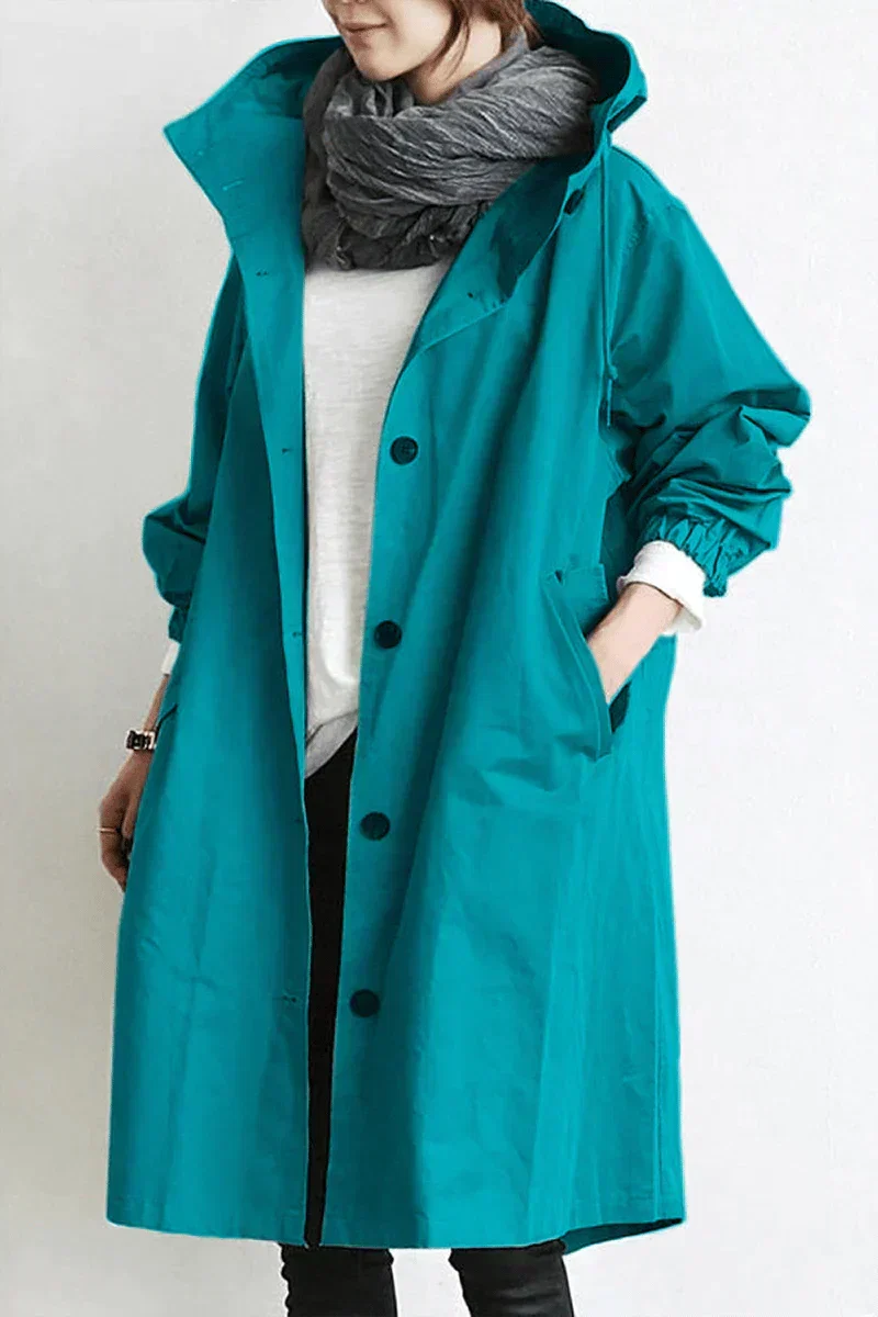 Side view of oversized hooded trench coat showing relaxed silhouette and roomy fit for layering knitwear