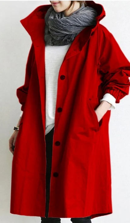 Front button closure detail on longline hooded trench coat with smooth-finish fabric