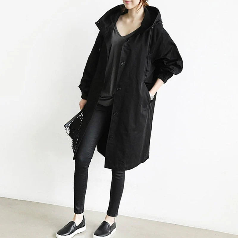 Oversized trench coat with hood up showing adjustable drawstring and full coverage fit